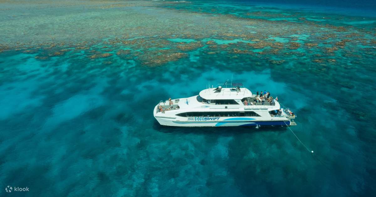 Catamaran at clear reef water